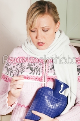 Woman with flu taking her temperature