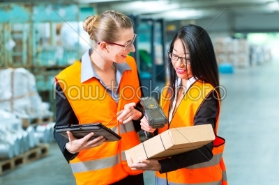 workers with package in warehouse of forwarding