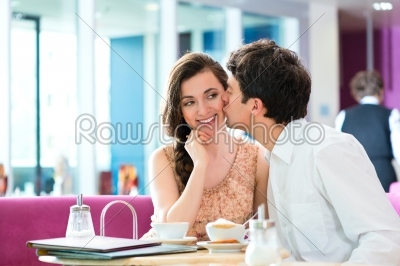 Young couple cafe hugging and kissing