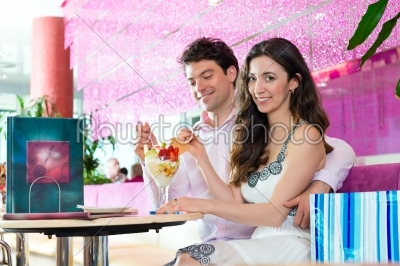 Young couple enjoying time in ice cream parlor