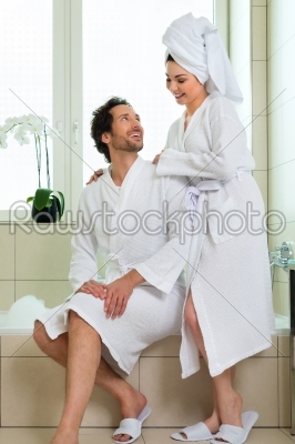 Young couple in bathrobe in hotel bathroom