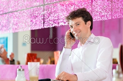Young man in ice cream parlor
