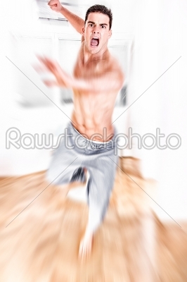 young man jumping with kicking and clenched fists