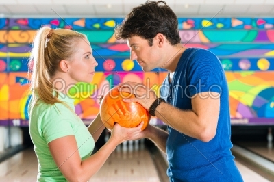 Young people playing bowling and having fun
