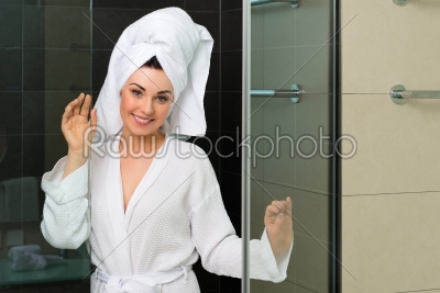 Young woman in bathrobe in hotel bathroom