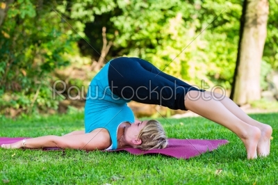 Young woman in nature doing yoga