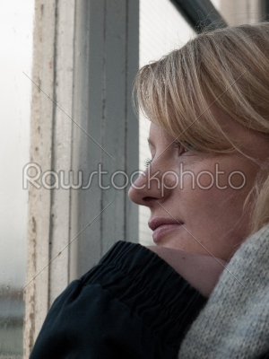 Young Woman Looking Out of a Window