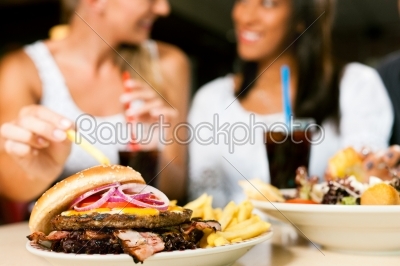 stock photo: two women eating hamburger and drinking soda-Raw Stock Photo ID: 51970