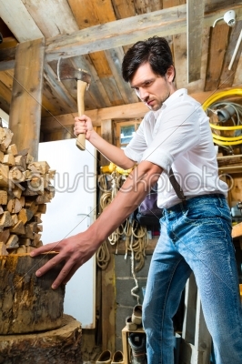 stock photo: young man chopping fire wood in mountain chalet-Raw Stock Photo ID: 49712